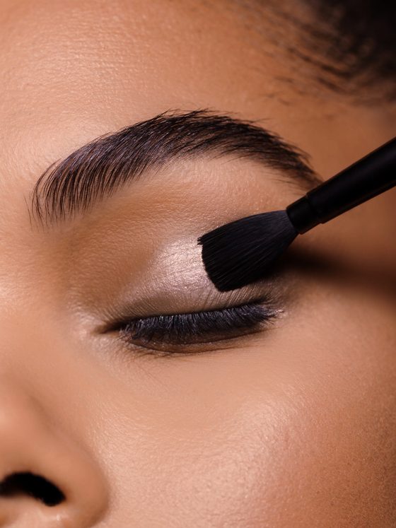 Makeup brush applying eye makeup