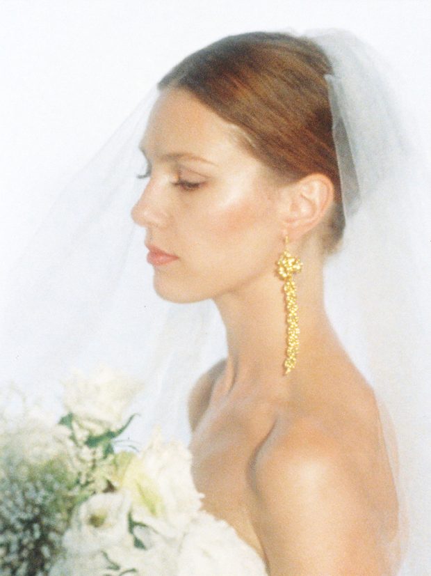 Bride in profile wearing polished bridal makeup
